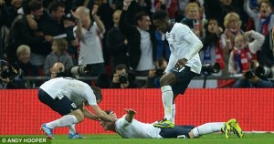 Rooney celebrates by mimicking Wellbeck's surfboard as team mates take it in turns to drag him around the pitch by the head for most of the second half.