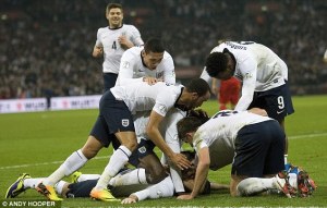 England players attempt to remove Rooney's head as a memento of tonight's historical victory.
